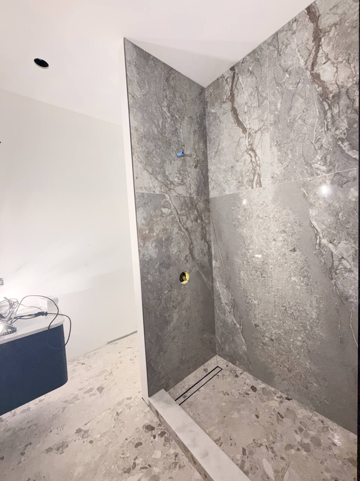 Shower large-format marble — during install