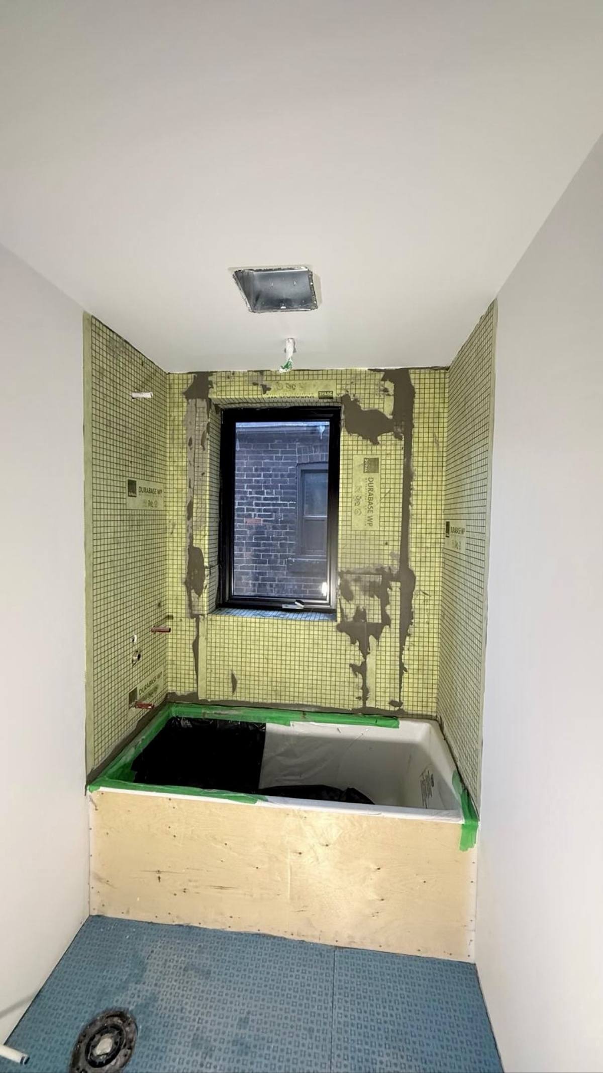 Bathroom green stacked tile — waterproofing prep
