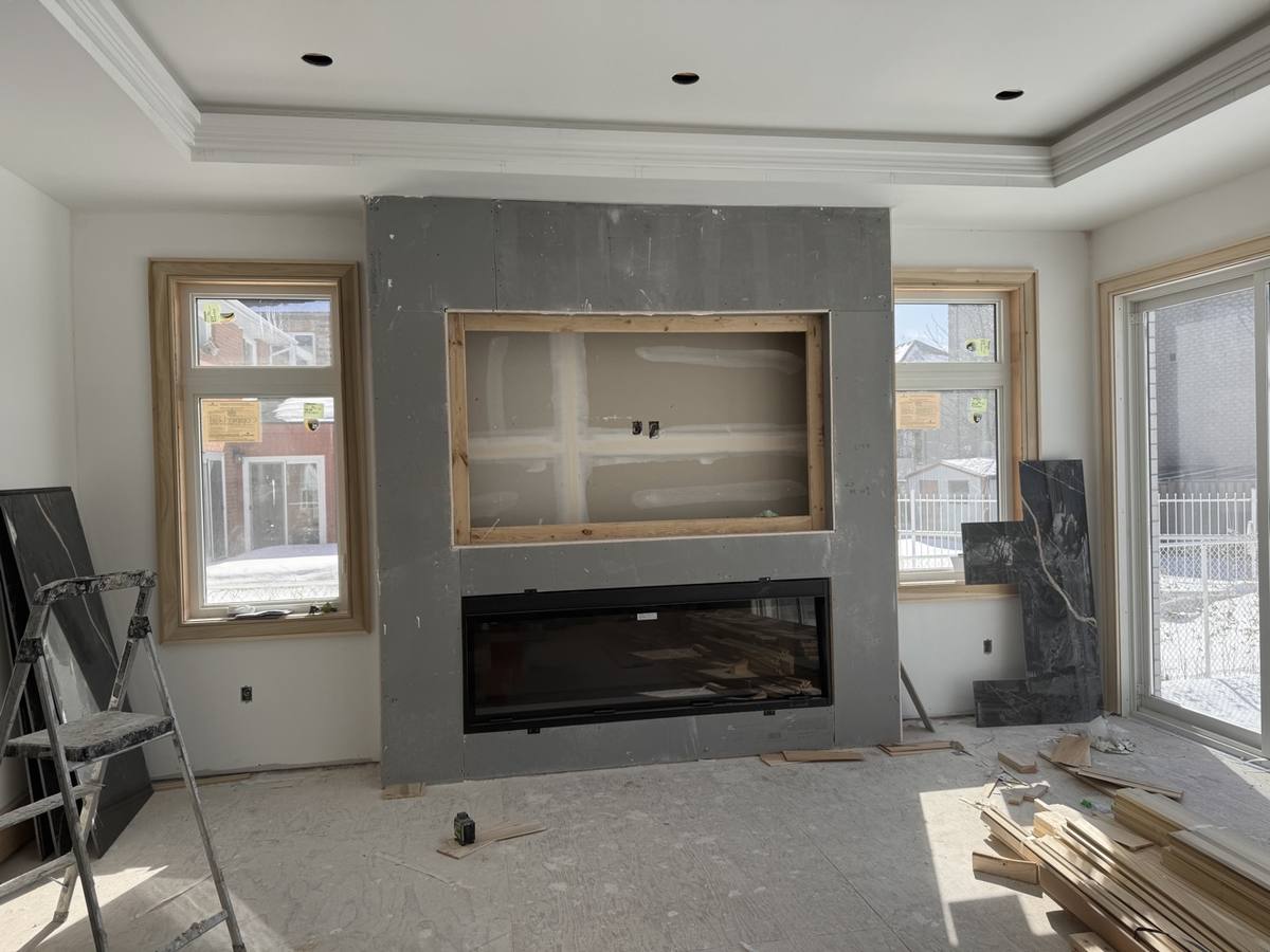 Fireplace black marble feature wall — during install